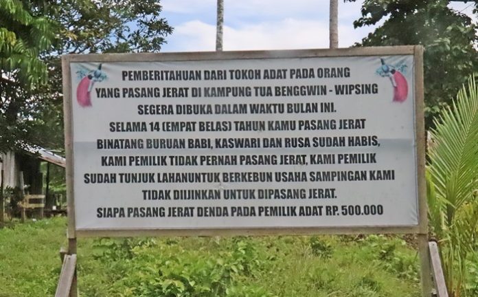 Plang Peraturan Kampung Larangan Berburu dan Pasang jerat di Kampung Benguin Progo, foto : nesta/jeratpapua.org